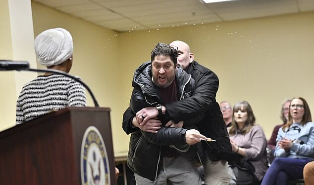 Ilhan Omar was attacked by a man who yelled that she 'should resign' before using a syringe to spray an unknown liquid at the Minnesota Congresswoman