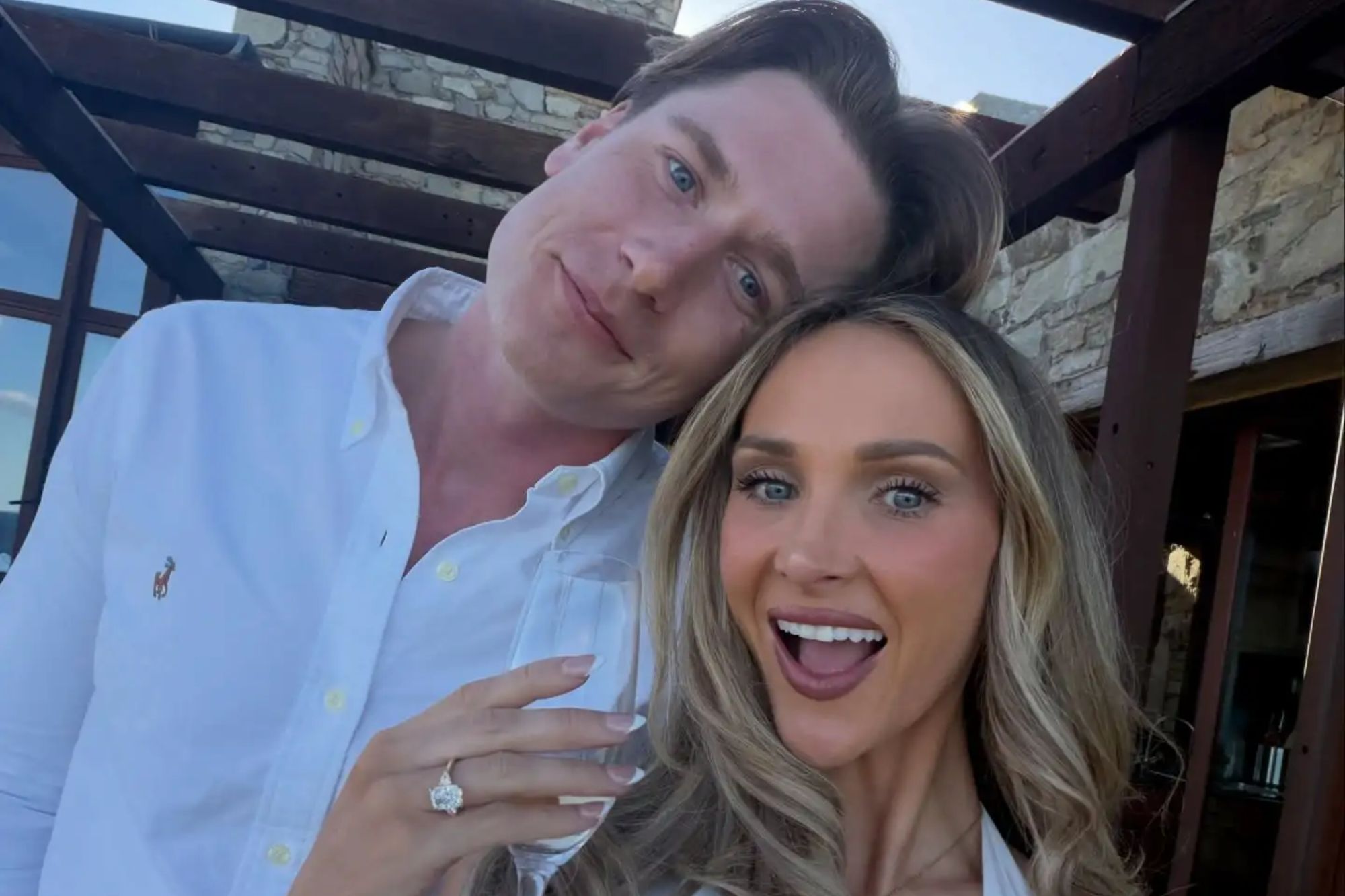 An image collage containing 1 images, Image 1 shows A woman wearing a large engagement ring and holding a champagne glass with a man smiling behind her