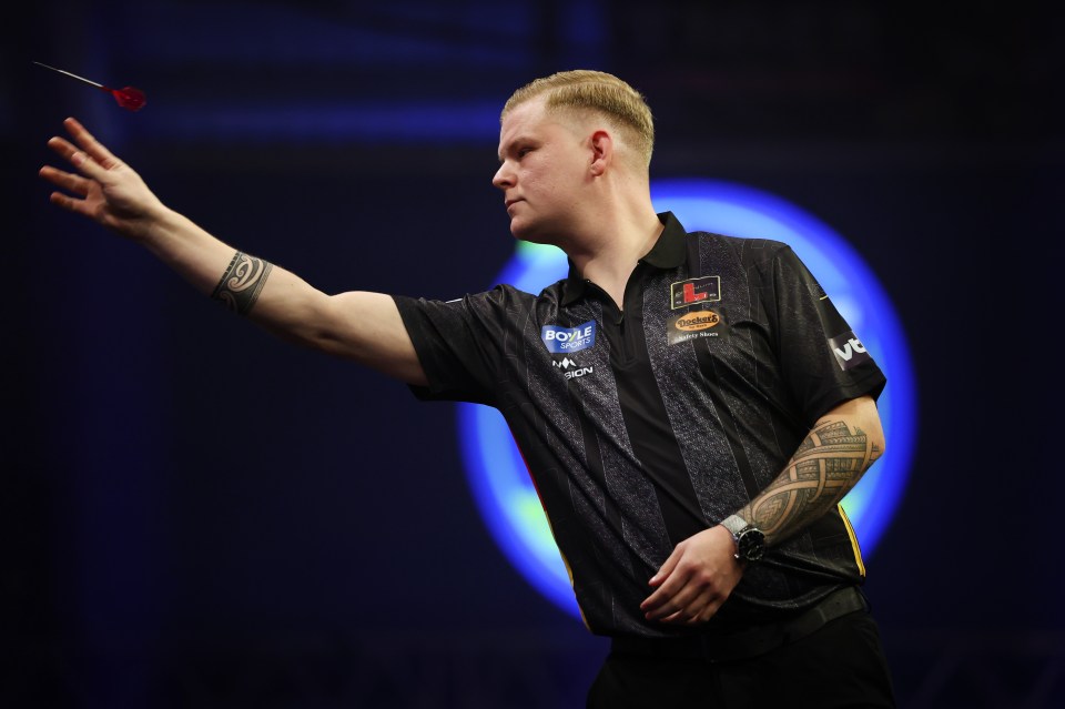 Mike De Decker of Belgium throwing a dart during a match.