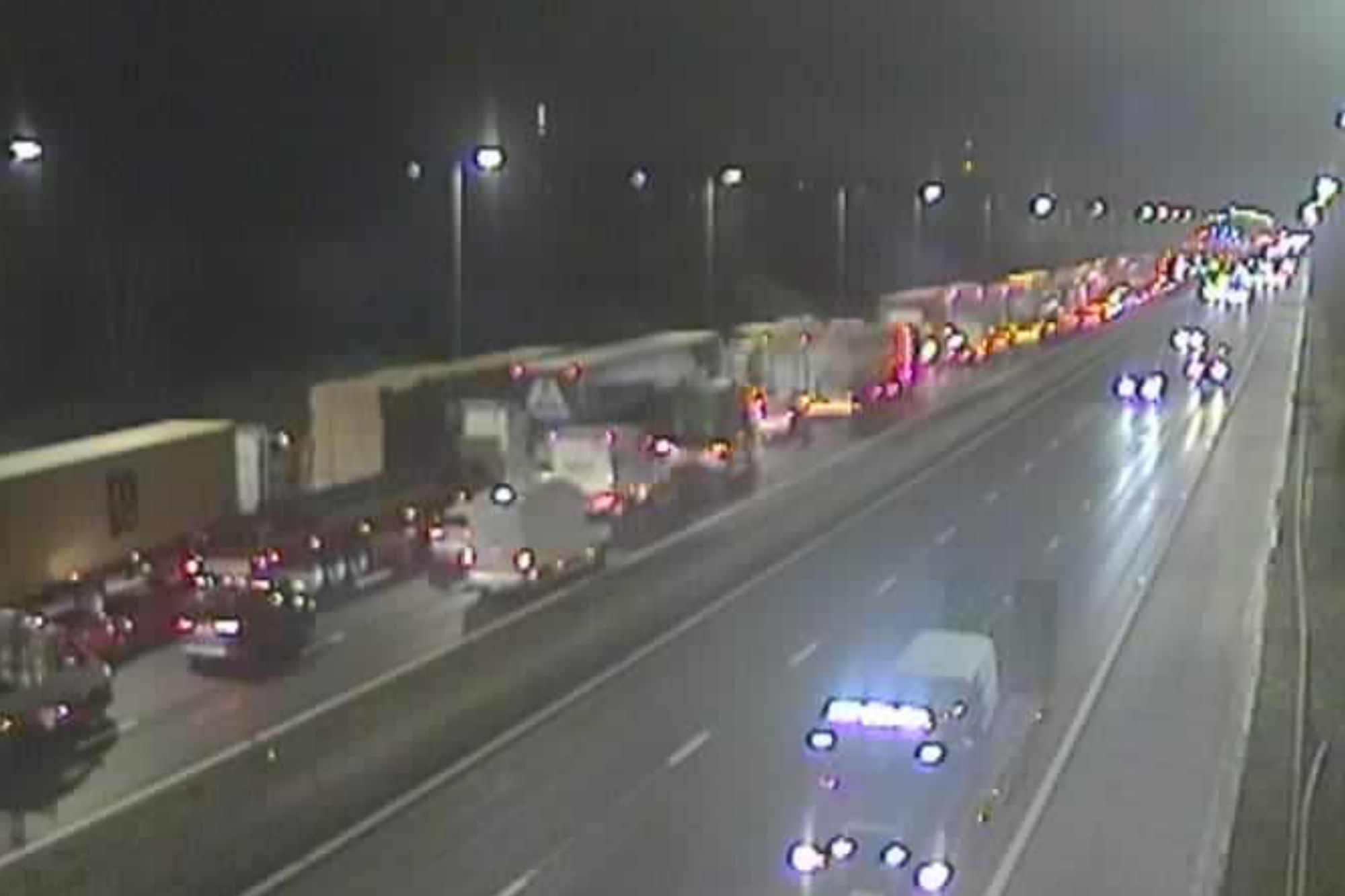 An image collage containing 1 images, Image 1 shows Nighttime highway traffic, with a traffic jam visible on the left side