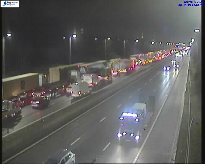 Nighttime highway traffic, with a traffic jam visible on the left side.