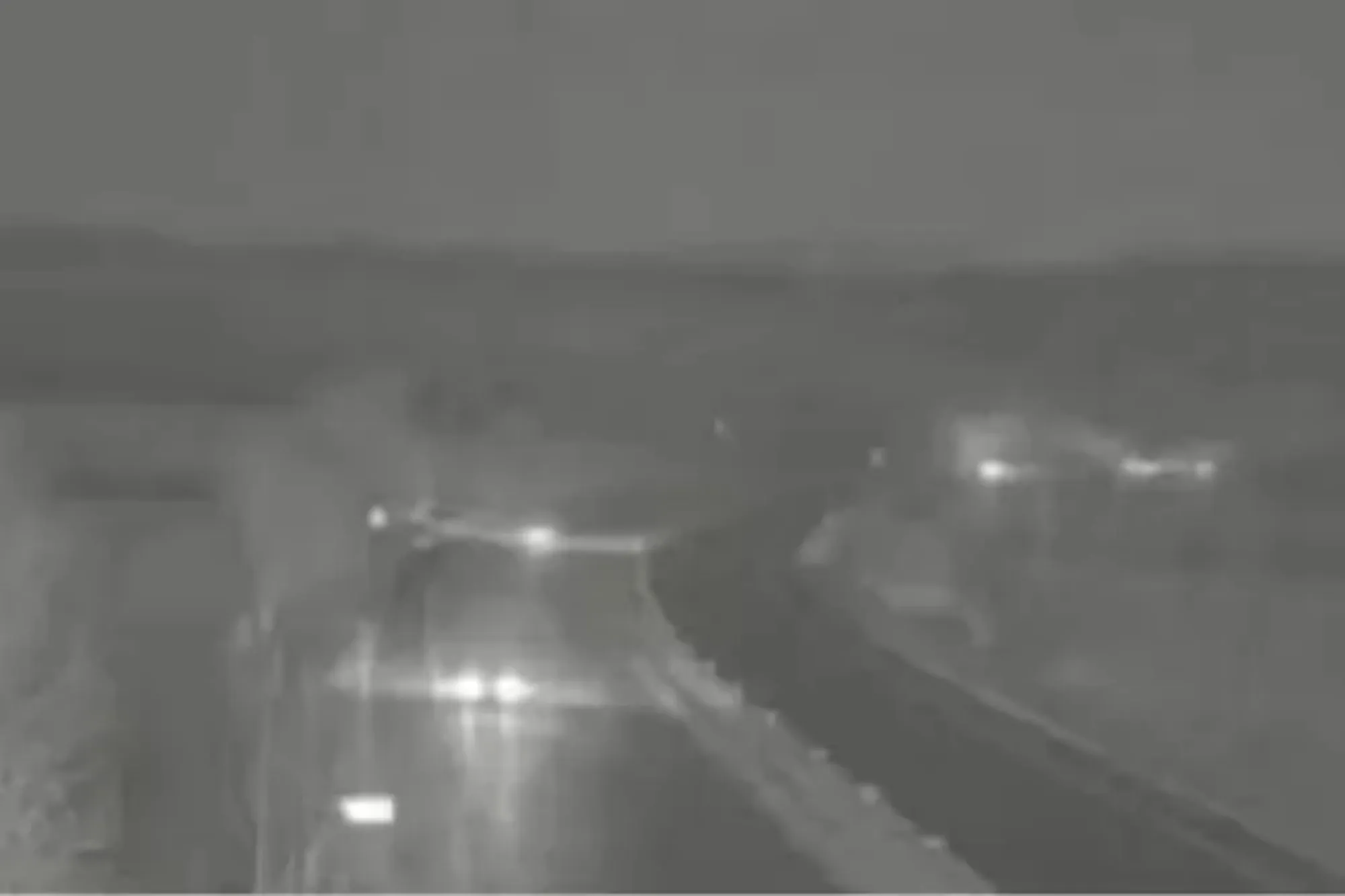 An image collage containing 1 images, Image 1 shows Night-time view of the M5 Motorway closed due to flooding from Storm Chandra, showing car headlights on the wet road