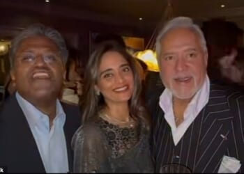 Ex-billionaire Vijay Mallya (right) and Pinky Lalwani (middle) smile as friend and tycoon Lalit Modi claims the two men are the 'biggest fugitives of India'