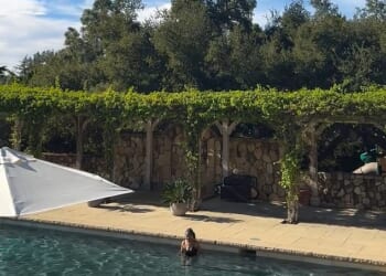 The sweet clips, uploaded to Instagram, show four-year-old Lilibet causing a splash in the water - accompanied by what appears to be Meghan's mother, Doria Ragland