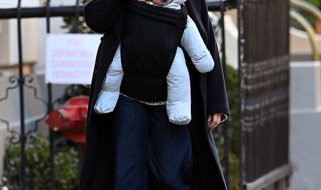 Michelle Williams was seen with her new baby for the first time on Wednesday - five months after revealing she had quietly welcomed a fourth child via surrogate