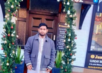 Ijaj Abid Redwan Hridoy, who also goes by the name Ijaj Ahmed, poses outside the Junoon Indian restaurant in Helsby, Cheshire, in December 2023 - less than four months after he was granted a care worker visa by the Home Office