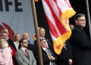 Speaker of the House Mike Johnson applauds on stage alongside fellow Republican lawmakers during the annual March for Life rally on the National Mall on Jan. 23, 2026, in Washington, D.C.