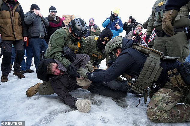 Border Patrol federal agents detain a demonstrator at a protest against the fatal shooting of Renee Nicole Good by a U.S. Immigration and Customs Enforcement (ICE) agent, during a rally against increased immigration enforcement across the city outside the Whipple Building in Minneapolis, Minnesota, U.S., January 8, 2026. REUTERS/Tim Evans     TPX IMAGES OF THE DAY