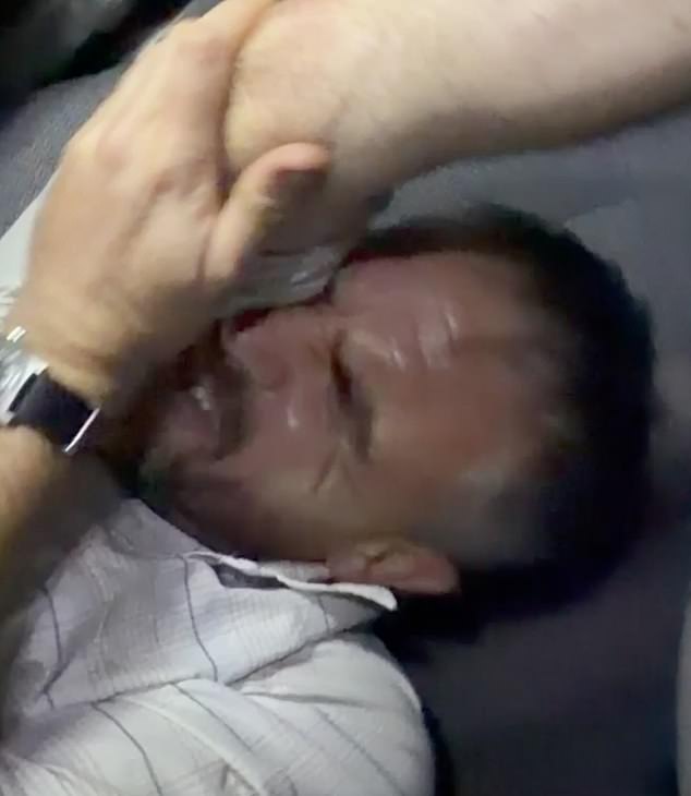 The explorer was seen wincing in pain as he tried to free himself from the overturned car