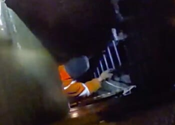 The moment a group of alleged thieves dressed as workers try to steal underground cables has been caught on camera