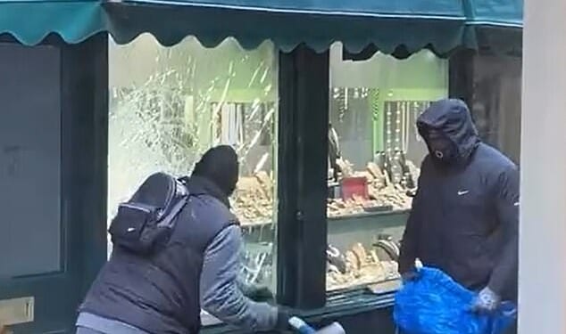 This is the moment hammer-wielding thugs broke into a family-run jewellers and ransacked the window display while brave staff tried to fend them off
