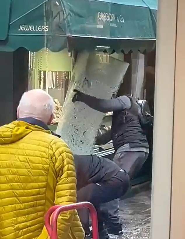 In footage, taken by a onlooker and shared widely on social media, two men can be seen swinging a larger hammer against the glass of the the family-owned jewellers Gregory & co