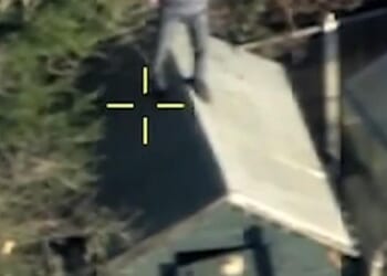 In footage taken from above, the 31-year-old suspect can be seen hiding inside a shed when he is spotted by the helicopter. Once he realises he has been spotted, the man makes a last ditch effort to avoid arrest by clambering onto the shed's roof