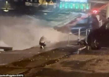 This is the moment a teenage girl is nearly swept out to sea while taking a selfie on a harbour wall during Storm Ingrid