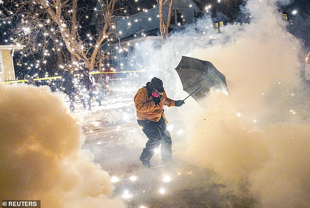 A protester seen being hit by pepper balls and gas on the streets of Minneapolis on January 14, 2026