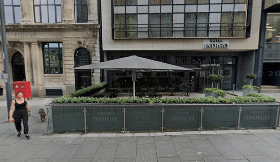Exterior of Marco Pierre White Steakhouse Bar & Grill Liverpool, with outdoor seating under an umbrella.