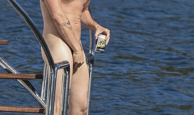 British rock star Yungblud, 28, took the term 'sun's out, buns out' quite literally as he sailed on Sydney Harbour naked on Thursday
