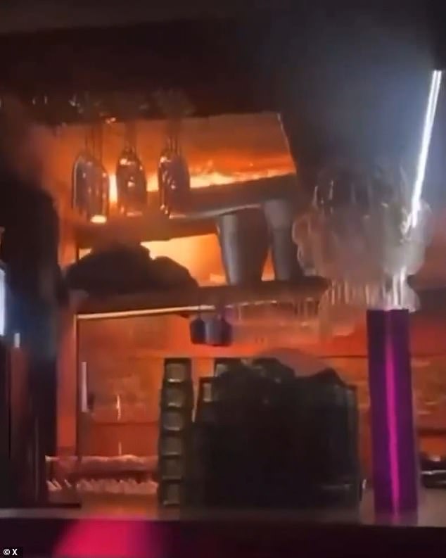 Dramatic footage shows enormous flames rapidly spreading over the ceiling of the cramped bar, as heavy music blares out of the speakers