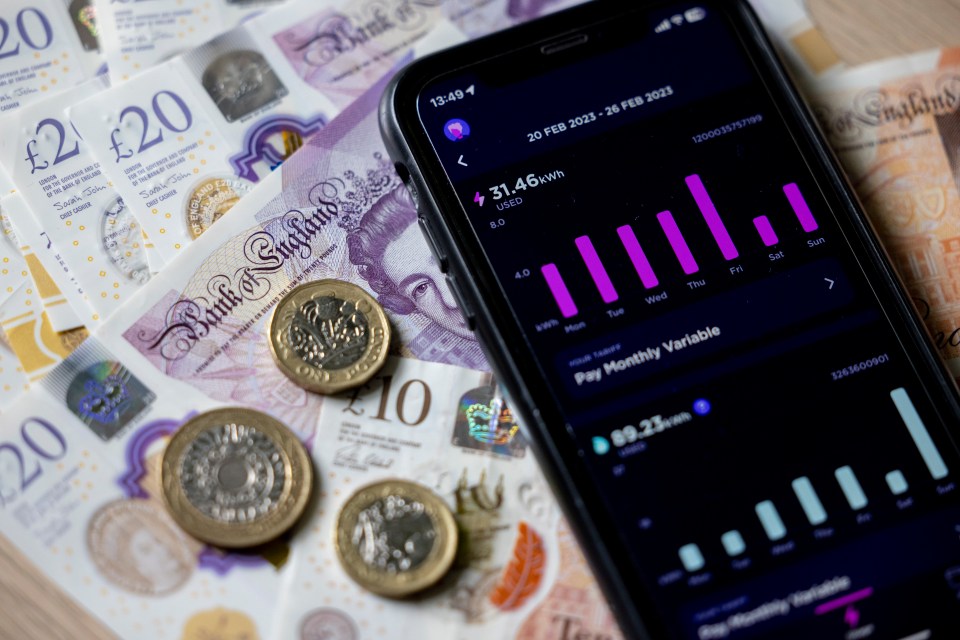 A smartphone displaying an energy usage app with British currency underneath, illustrating rising energy costs.