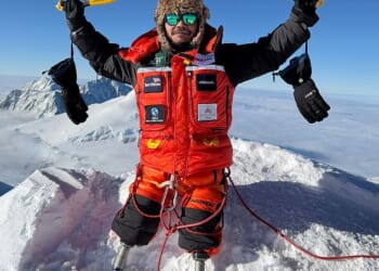 Hari Budha Magar raises his ice picks in victory at the summit of Mount Vinson in Antarctica
