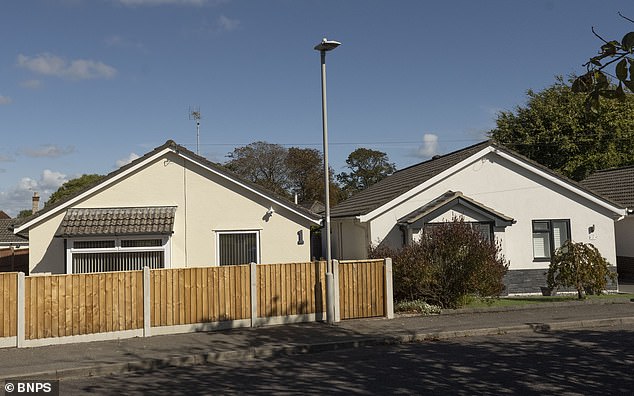 The bungalows overlook a green with trees in the quiet cul-de-sac
