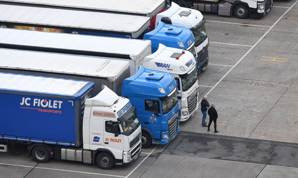 Drivers stand with their lorries, queued at the Port of Dover waiting to board a ferry to Europe.
