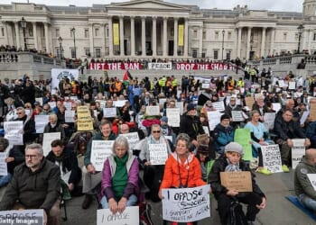Activists defy the Palestine Action ban by holding illegal signs in Trafalgar Square, ventral London, on October 4 last year