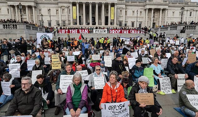 Activists defy the Palestine Action ban by holding illegal signs in Trafalgar Square, ventral London, on October 4 last year
