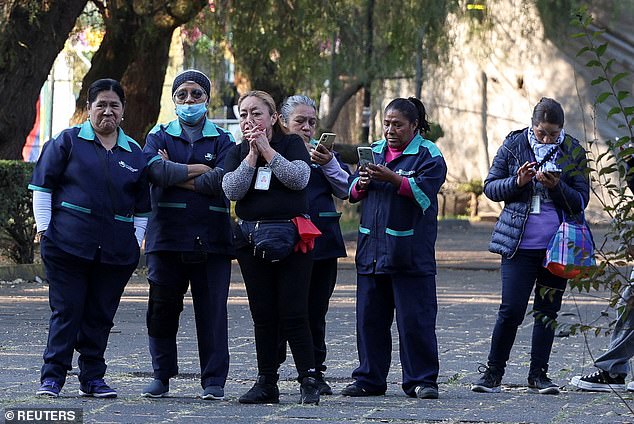 People stand after leaving a building following an earthquake, Mexico City, Mexico, January 2, 2026