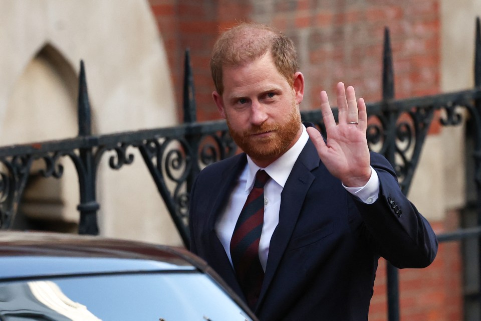 Prince Harry, Duke of Sussex, waves while departing Britain's High Court.