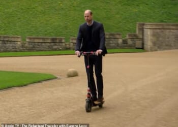 Prince William has reportedly been banned from riding his e-scooter within the ground of his new home in Windsor Great Park. He is seen here riding his scooter during an episode for Eugene Levy's Apple+ TV series The Reluctant Traveler