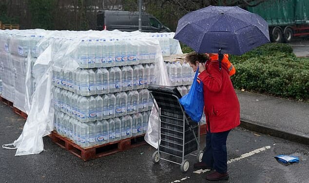 A South East Water customer arrives to collect bottled water at a water station in East Grinstead, after bad weather was blamed for more water outages in Kent and parts of Sussex