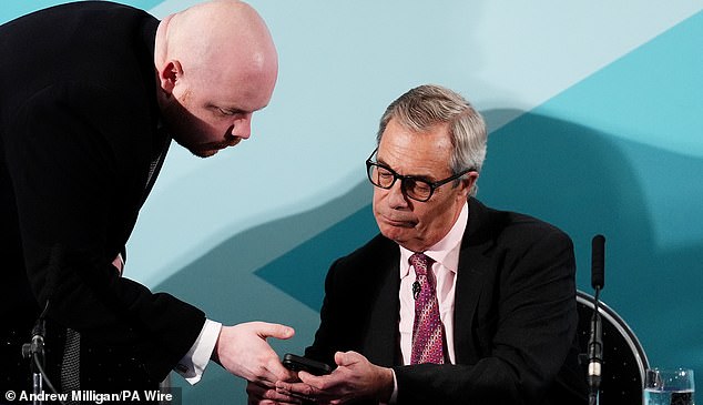 Reform UK leader Nigel Farage checks his phone during a press conference announcing Malcom Offord as the Scottish leader of Reform UK, at Dean Park Hotel, Kirkcaldy. Picture date: Thursday January 15, 2026. PA Photo. Photo credit should read: Andrew Milligan/PA Wire