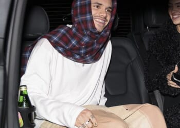 Romeo Beckham and his girlfriend Kim Turnbull couldn't stop smiling as they stepped out together in Paris amid his older brother Brooklyn's scathing post towards his family