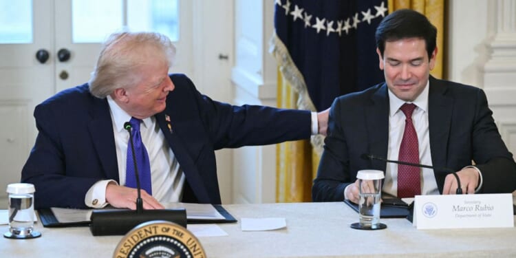 President Donald Trump speaks with Secretary of State Marco Rubio during a meeting with American oil executives in the East Room of the White House in Washington, DC on Jan. 9, 2026.