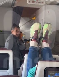 Shock moment plane passenger from hell rests her FEET on headrest