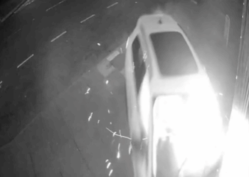 Shocking moment driver with no licence speeds down road and smashes Audi straight into barber shop