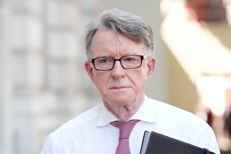 Lord Peter Mandelson, then UK Ambassador to the US, wearing a white shirt and red tie, arriving at the Cabinet Office.