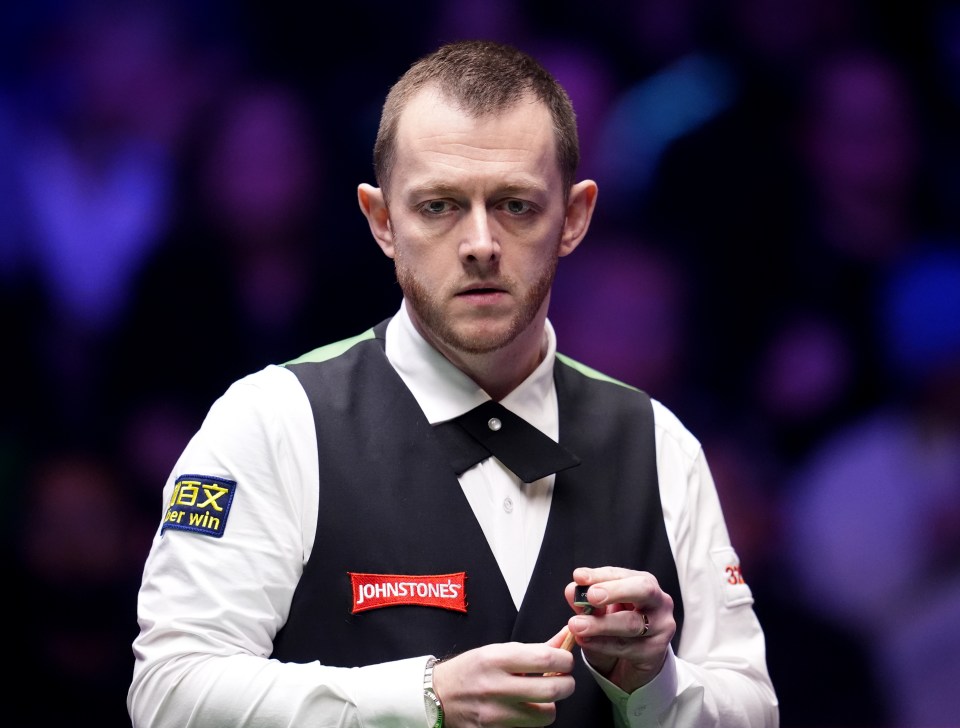 Mark Allen holding a snooker cue.