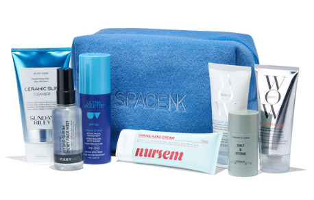 A blue Space NK beauty box and various skincare products.