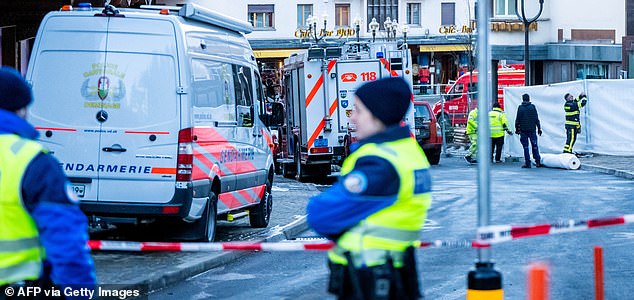 Police officers stand guard at the site of an explosion that ripped through a bar in Crans-Montana on January 1, 2026. Several people were killed and others injured when an explosion ripped through a bar in the luxury Alpine ski resort town of Crans Montana, Swiss police said early on January 1. (Photo by MAXIME SCHMID / AFP via Getty Images)