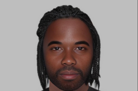 E-fit illustration of a black man with an oval face, neck-length dreadlocks, and a short beard.