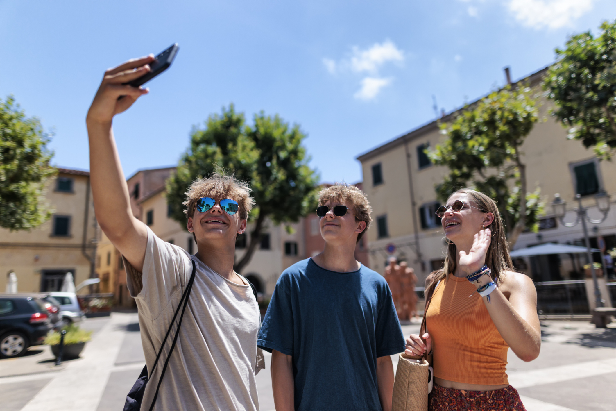 a man taking a selfie with two other people