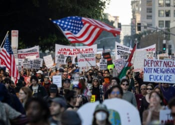 People wave flags and hold signs during a protest in Los Angeles, California, on Jan. 10, 2026, against U.S. Immigration and Customs Enforcement after the fatal shooting of Renee Nicole Good in Minneapolis, Minnesota.