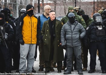 Border Patrol chief Gregory Bovino observes a protest in Minneapolis on January 15