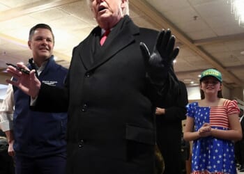 Representative Zach Nunn (R-IA) and his daughter Olympia look at U.S. President Donald Trump as he speaks, in Machine Shed restaurant in Urbandale, Iowa, on Tuesday