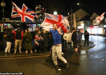Photos show protesters gathered on Crowborough's High Street last night, holding England and Union Jack flags