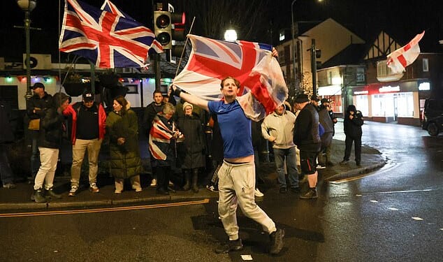Photos show protesters gathered on Crowborough's High Street last night, holding England and Union Jack flags