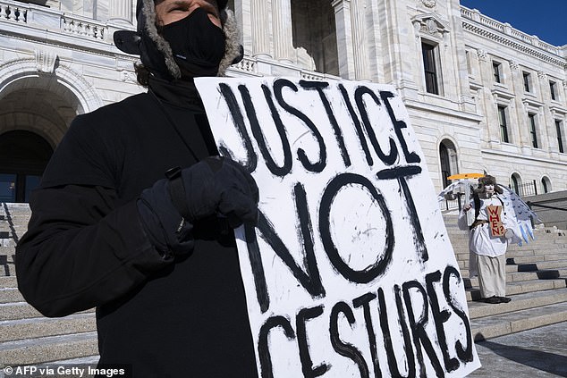 Anti ICE protesters stand outside the Minnesota State Capitol Building