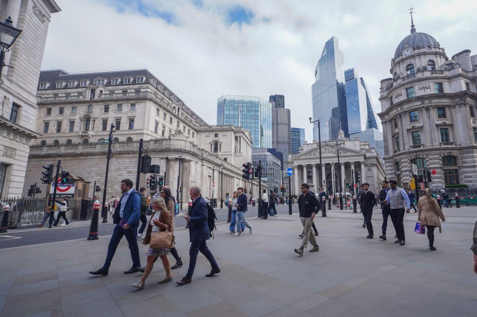 People walking near the Bank of England in London.